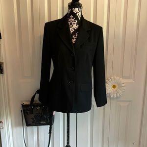 Classic Talbots petites black blazer w/three button closure& faux flap pockets.